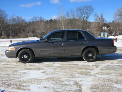 2001 Ford Crown Victoria - A gray 2001 Ford Crown Victoria is parked outside on a clear, cold day with snow on the ground.