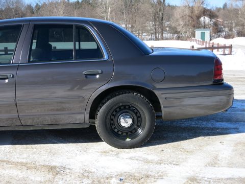 2001 Ford Crown Victoria - Side profile of a 2001 Ford Crown Victoria sedan parked outdoors in winter.