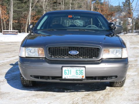2001 Ford Crown Victoria - Front view of a 2001 Ford Crown Victoria parked on a snowy road.