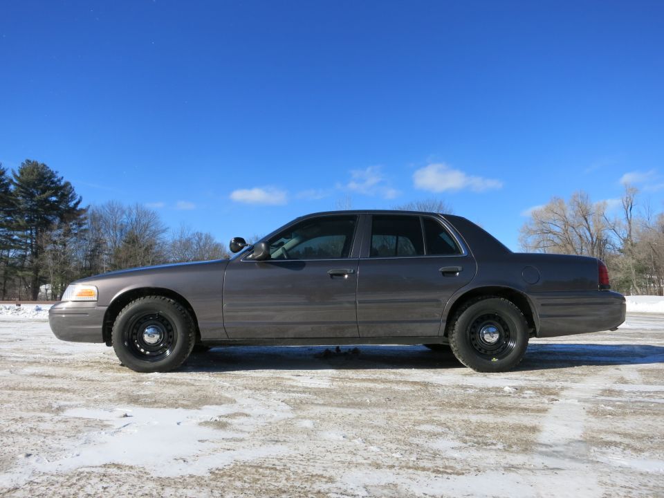 2001 Ford Crown Victoria side profile in a snowy lot