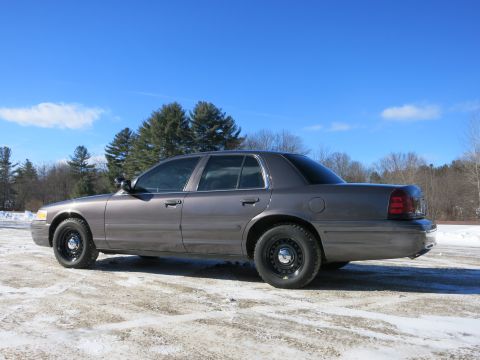 2001 Ford Crown Victoria - A gray 2001 Ford Crown Victoria is parked outside on a bright, clear day with snow on the ground.