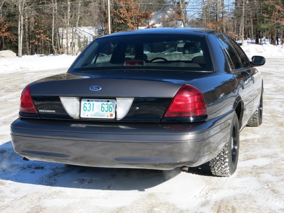 Rear view of a 2001 Ford Crown Victoria parked on a snowy road