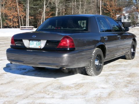 2001 Ford Crown Victoria - This dark gray 2001 Ford Crown Victoria is seen from the rear in a snowy environment.