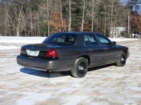 2001 Ford Crown Victoria - Dark gray 2001 Ford Crown Victoria with steel wheels on a winter day.