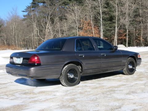 2001 Ford Crown Victoria - Dark gray 2001 Ford Crown Victoria sedan with winter tires on a snowy road.