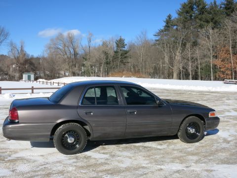 2001 Ford Crown Victoria - Side view of a 2001 Ford Crown Victoria in a snowy outdoor setting.