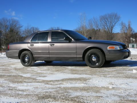 2001 Ford Crown Victoria - A gray 2001 Ford Crown Victoria is seen from the side in a winter setting.