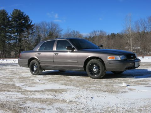 2001 Ford Crown Victoria - This 2001 Ford Crown Victoria sedan is shown in a three-quarter front view, parked outdoors on a cold, snowy day.