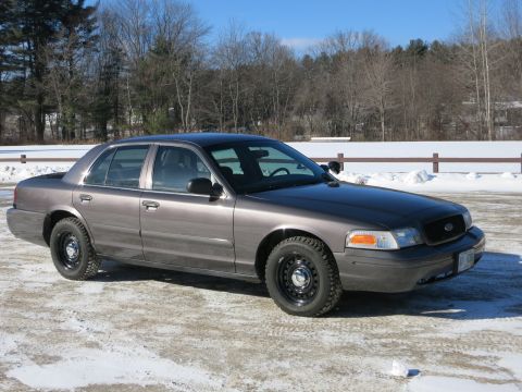 2001 Ford Crown Victoria - Gray 2001 Ford Crown Victoria with black steel wheels in a winter setting.