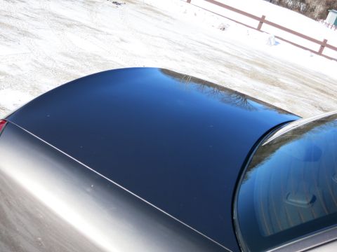 2001 Ford Crown Victoria - View of a car's roof and rear window on a snowy day.