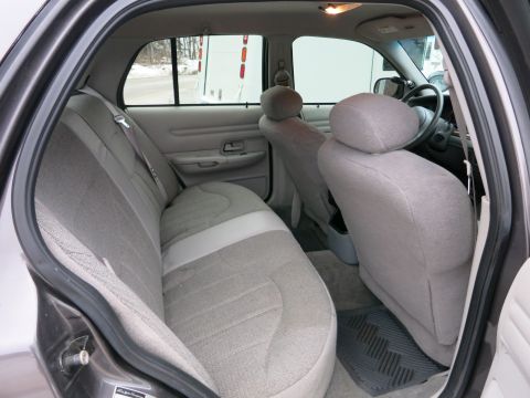2001 Ford Crown Victoria - Rear interior view of a sedan, showing the back seat, front seats, and dashboard.