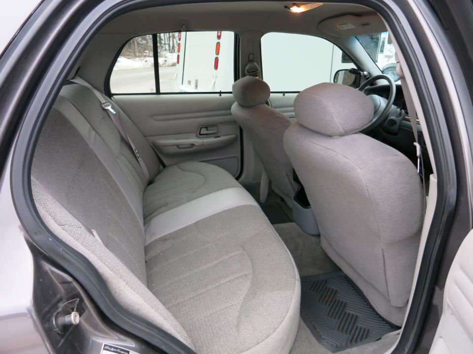 Interior rear seats and dashboard of a gray sedan