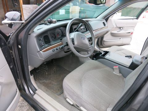 2001 Ford Crown Victoria - The interior of a 2001 Ford Crown Victoria, the dashboard, steering wheel, and passenger seat.