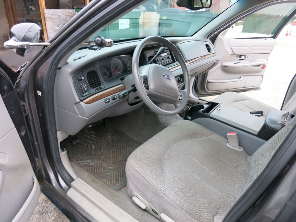 Interior of a 2001 Ford Crown Victoria, showing dashboard and passenger seat
