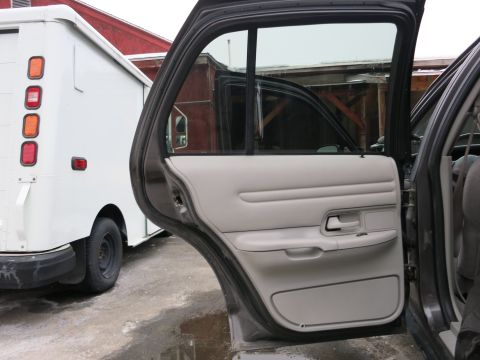 2001 Ford Crown Victoria - Rear door open showing the interior door panel of a 2001 Ford Crown Victoria.