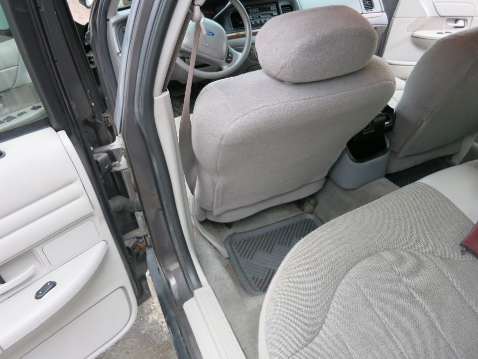 Interior view of a 2001 Ford Crown Victoria, showing front seats and dashboard
