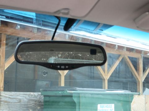 2001 Ford Crown Victoria - View from inside a vehicle, looking at the rearview mirror and the exterior scene.