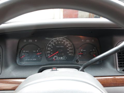 2001 Ford Crown Victoria - The dashboard gauges of a 2001 Ford Crown Victoria display mileage, gear selection, and temperature readings.
