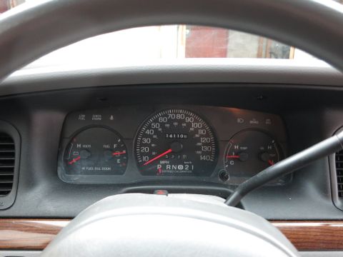 2001 Ford Crown Victoria - Interior view of a 2001 Ford Crown Victoria dashboard with gauges and steering wheel visible.
