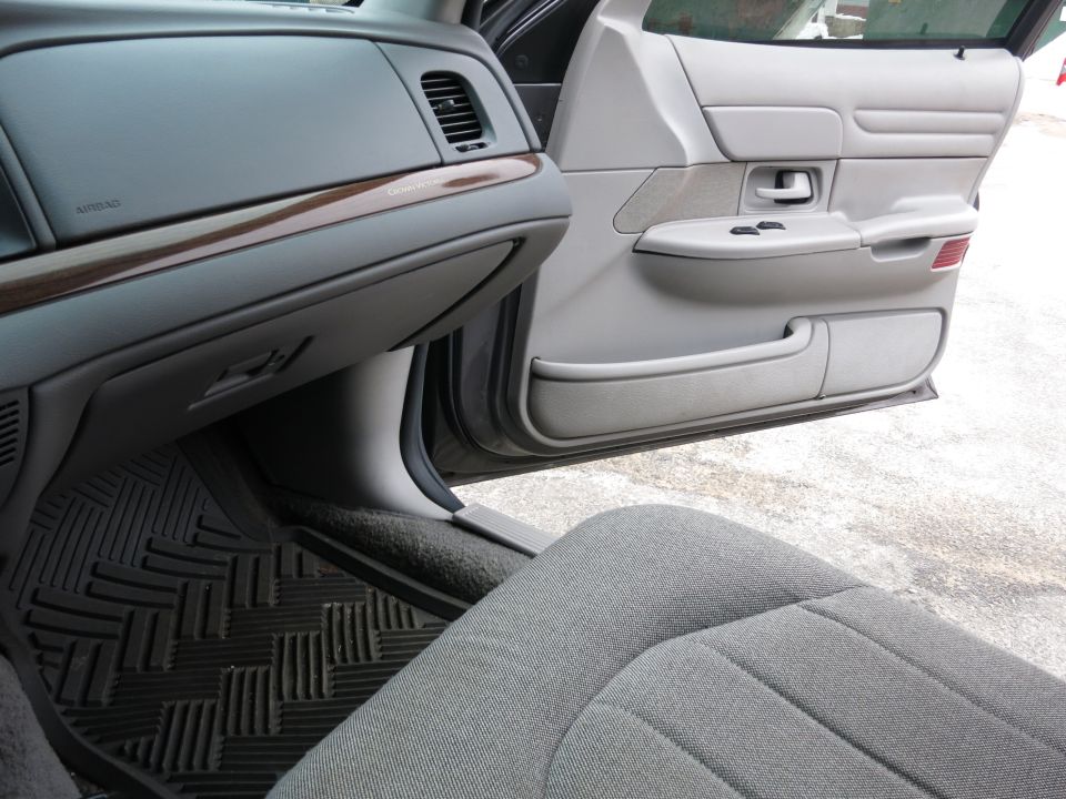 2001 Ford Crown Victoria interior showing dashboard, glove box, door panel, and seat