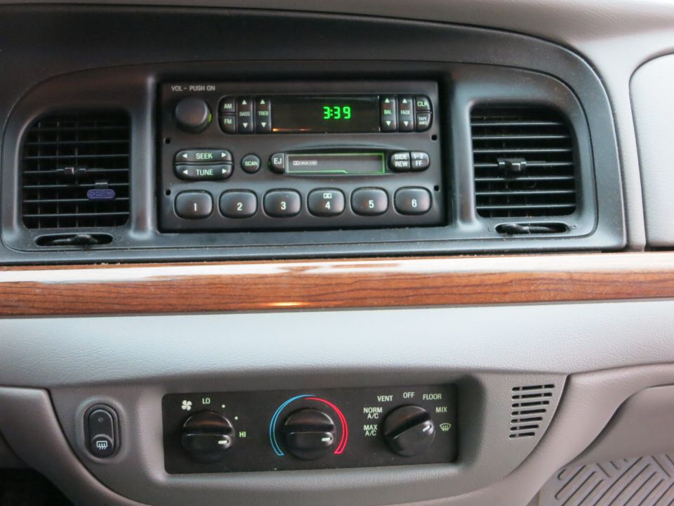 Dashboard of a 2001 Ford Crown Victoria with radio and climate controls
