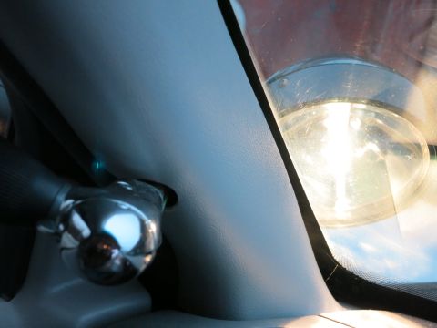 2001 Ford Crown Victoria - Close-up of a car's interior, focusing on the steering column and windshield reflection.
