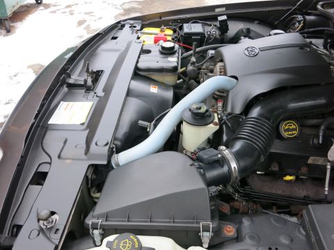 2001 Ford Crown Victoria - Close-up view of the engine compartment, highlighting various components and hoses under the hood.