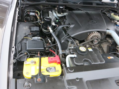 2001 Ford Crown Victoria - Engine bay of a 2001 Ford Crown Victoria, showing the battery and engine components.