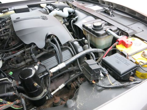 2001 Ford Crown Victoria - Close-up view of a vehicle's engine compartment, showing various components and wiring.