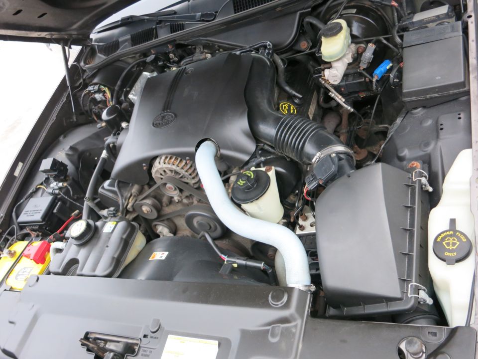2001 Ford Crown Victoria engine bay with V8 engine, air intake, and coolant reservoir visible