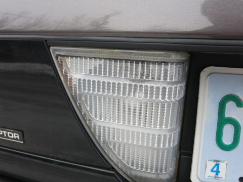 2001 Ford Crown Victoria - The rear of a vehicle, showing a clear tail light assembly and a license plate.