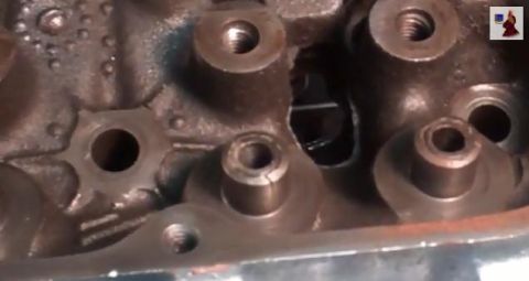 1967 Pontiac Grand Prix - This is a close-up view of an engine's cylinder head, showing internal components and bolt holes.
