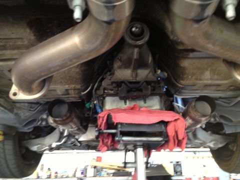 2004 Ford Crown Victoria - Underside view of a vehicle's exhaust and transmission system, possibly undergoing maintenance or modification.