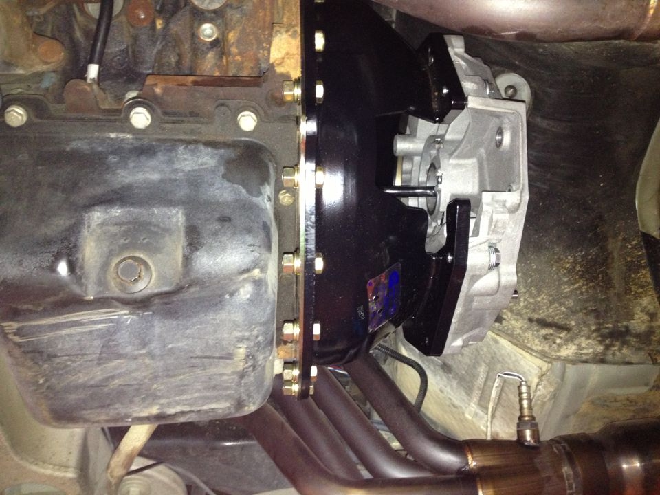 Close-up of engine block, transmission bell housing, and exhaust headers