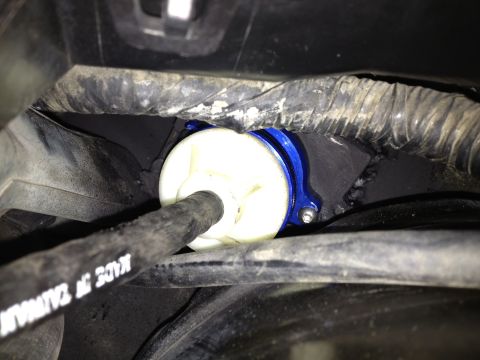 2004 Ford Crown Victoria - Close-up of a blue anodized part with a white cylinder and a black hose, with 'MADE IN TAIWAN' visible on the hose.