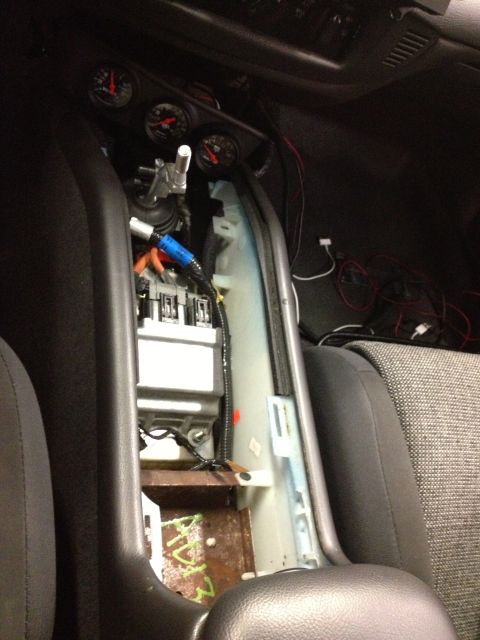 2004 Ford Crown Victoria - Center console removed in car interior, revealing wiring and gauges.