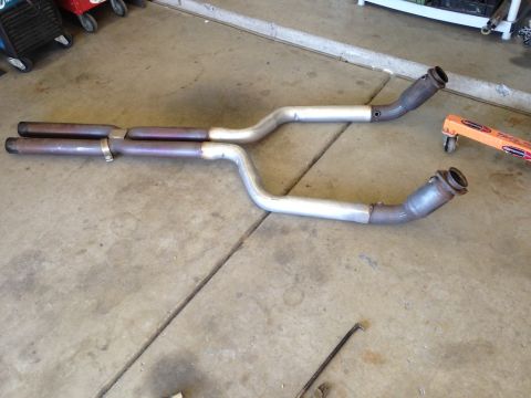 2010 Dodge Challenger - Exhaust system components, likely from a performance vehicle, are shown on a garage floor.