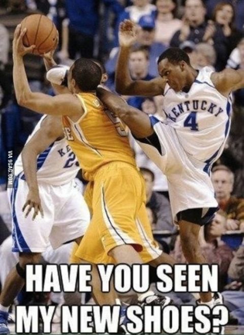 2000 Mercury Grand Marquis - A basketball player in a yellow uniform is being kicked by a player in a Kentucky jersey, with text asking about new shoes.