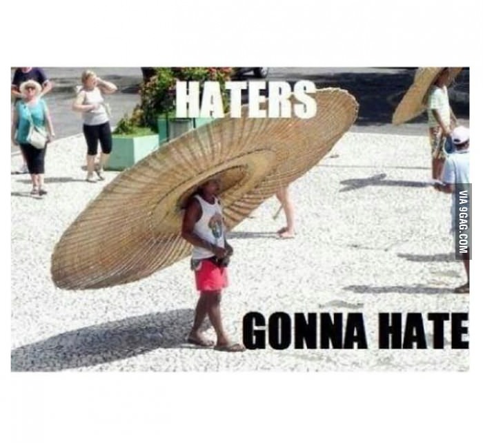 Person in red shorts and white tank top wears a giant straw hat, with text "HATERS GONNA HATE"