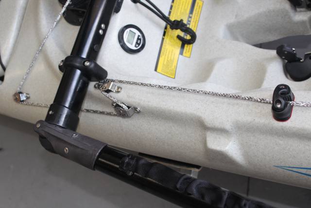 Kayak rigging with black pole, ropes, and a digital display