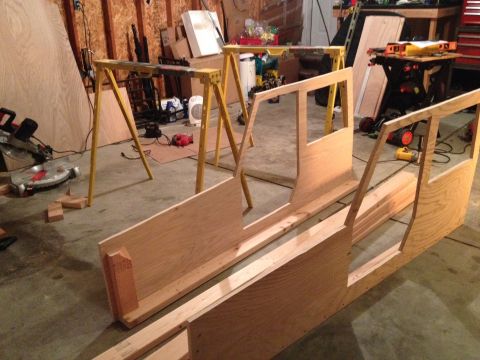 2005 Jeep Wrangler - Wooden frame construction is underway in a workshop, with tools and lumber visible in the background.