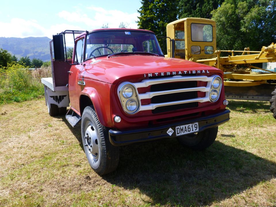 Red International truck front view with white grille and license plate DMA619
