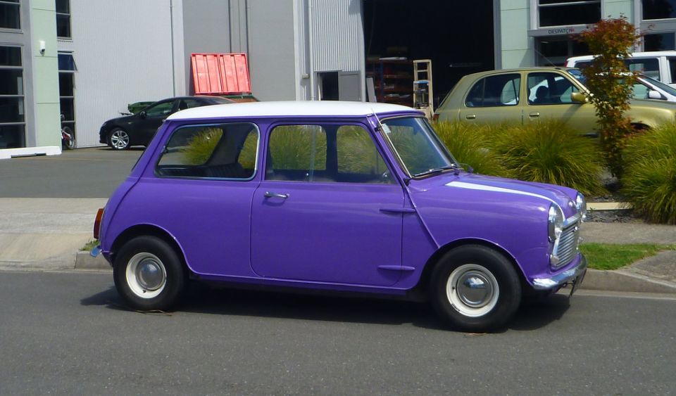 Purple Mini Cooper with a white roof parked on a street