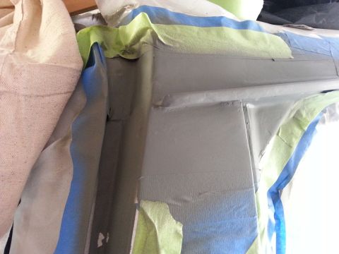 1992 Ford Bronco - Automotive body panel being prepped for repair with masking tape applied.
