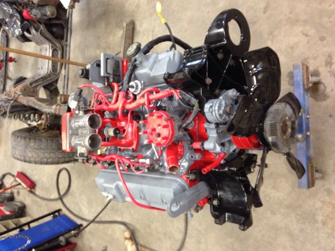 1993 Ford Bronco - Engine assembly with custom paint and dual carburetors, likely for a performance build.