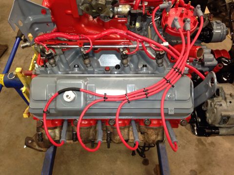 1993 Ford Bronco - This V8 engine features a red-painted intake manifold and distributor cap, with prominent red spark plug wires.
