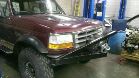 1996 Ford Bronco - This 1996 Ford Bronco features a custom front bumper with an integrated winch, suggesting off-road modifications.