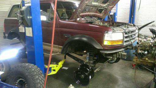 1996 Ford Bronco front view with hood open, on a lift