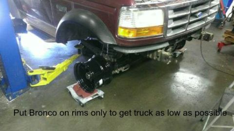 1996 Ford Bronco - Front end of a 1996 Ford Bronco on a lift with the front wheel removed.