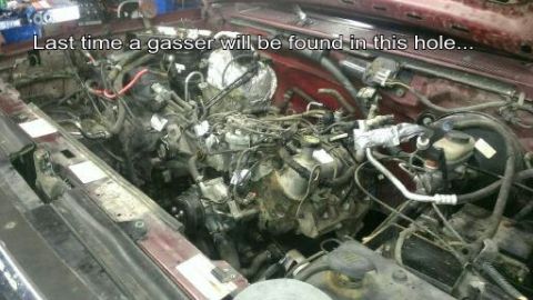 1996 Ford Bronco - The engine bay of a vehicle, filled with intricate wiring and mechanical parts, with text overlaying the image.
